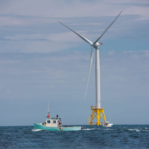 Fishing Boats Near Wind Turbine