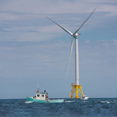 Fishing Boats Near Wind Turbine